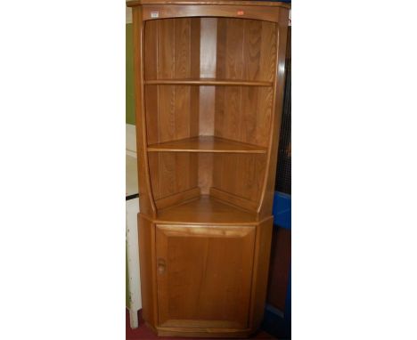 A contemporary Ercol blond elm freestanding corner cupboard
