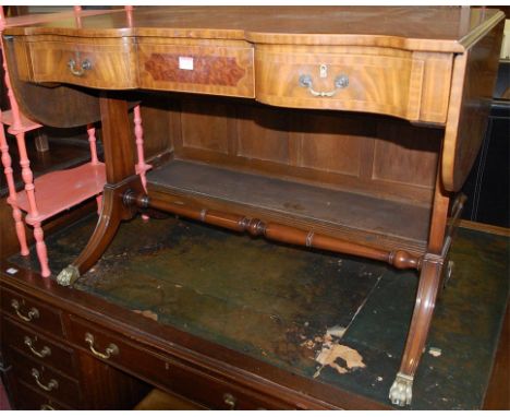 A reproduction mahogany and satinwood strung dropflap sofa table, having three frieze drawers, on outswept supports to turned