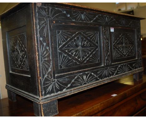 An early 20th century low relief and line carved hinge topped twin panel coffer, width 92.5cm