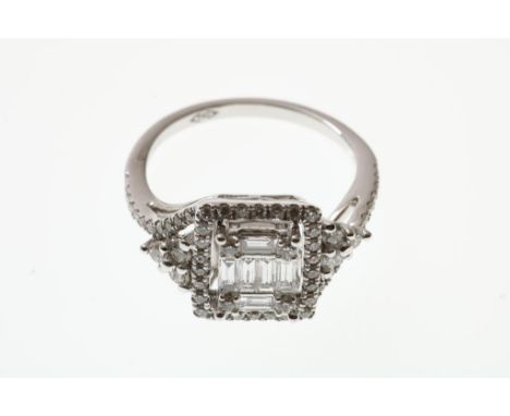 A whitegolden ring with brilliant - baguette cut. size 17  585/000, gross weight 4.5 gr.Witgouden ring bezet met diamanten br