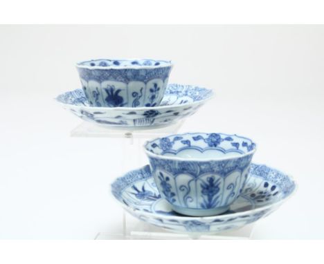 2 Kangxi cups and saucers decorated with long lines, flowers,  leaves and napkin work, h. cup 4 cm, diam. saucer 11,5 cm.  Co