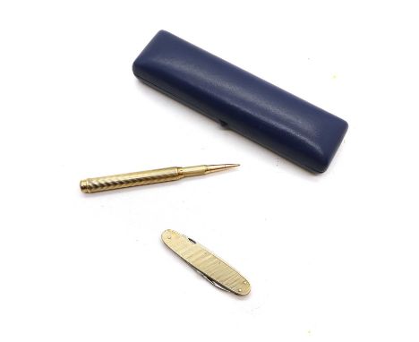 A 9ct gold propelling pencil by Sampson Mordan, with engine-turned decoration, 11cm long together with a gold cased cigar cut