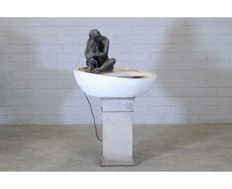 A stone fountain,  contemporary, the dished bowl surmounted with a resin bronze of a seated boy, raised on a square plinth, 7