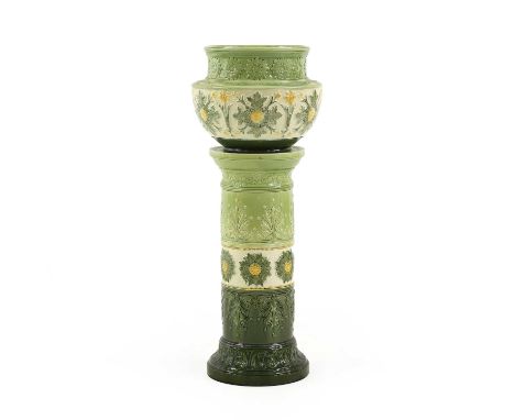 A glazed pottery jardinière and stand, 19th century, with moulded designs in cream, yellow and green glazes, stamped marks 'L