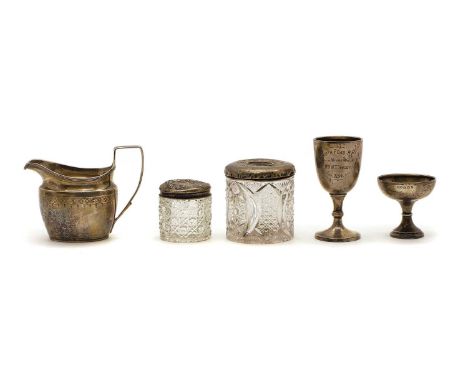 A group of silver item comprising a Georgian silver cream jug, 9.5cm high, a small silver trophy, 'Ripon Spa B.C. Winner Mrs 