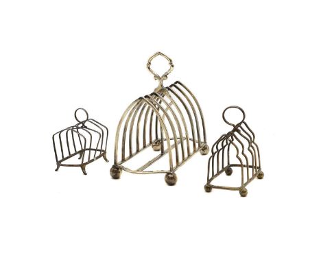 A group of three silver toast racks comprising a six division example, by William Hutton & Sons Ltd, London 1902, 18cm wide, 