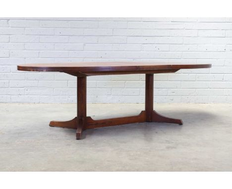 § An extending rosewood dining table, 1950s, designed by Robert Heritage for Archie Shine, the oval top raised on pillar supp