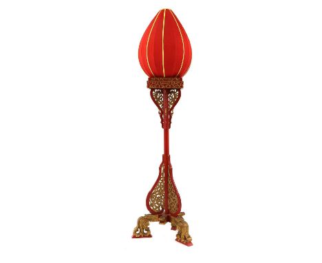 A Chinoiserie painted standard lamp with a fabric lantern, to a painted column, with pierced gilt dragons, raised on a tripod