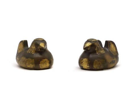 A pair of Japanese parcel-gilt bronze screen holders,  late Meiji period, modelled as mandarin ducks, each cast with wings fl