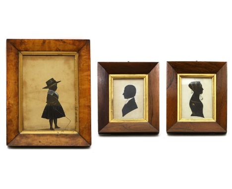 Three Victorian silhouettes comprising; a pair of portraits, of a lady and gentleman, the reverse inscribed 'Barbara... died 