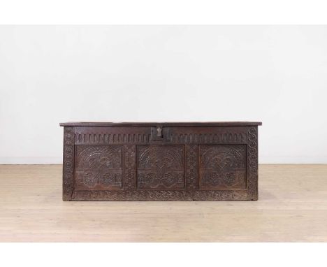A James I carved oak chest, early 17th century, West Country, of joined construction, the hinged lid above an elaborately car
