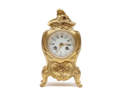 A French gilt brass mantel clock, second half 19th century, the waisted case surmounted by a foliate cast, centered by the wh