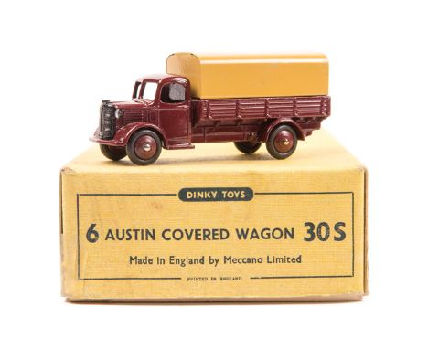 A Dinky Toys Trade Box of Austin Covered Wagon 30S. Containing one later example (413) in maroon with tan tin tilt and maroon