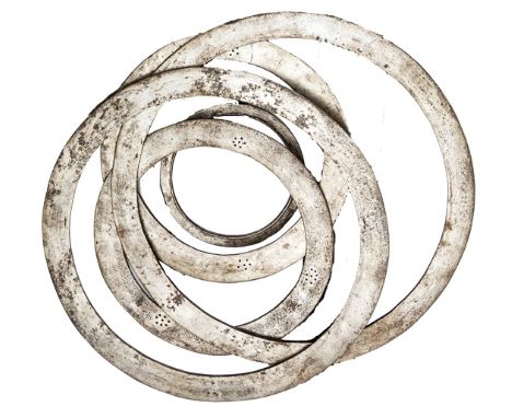 A scarce set of five 19th century Sikh chakram (throwing rings), worn on the turban, the rims sharpened, one pair 18¾” diam, 