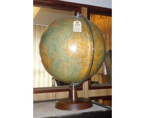 A Philips 13.5" Terrestrial Globe. A 1964 copyrighted example, pasted sectional card surface. Mounted on a circular wooden ba