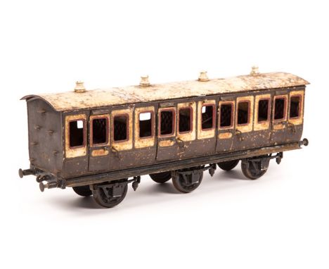 A Bing gauge 3 (2.5" gauge) tinplate 6-wheel suburban passenger coach. (1908-1925 period), finished in chocolate & cream live