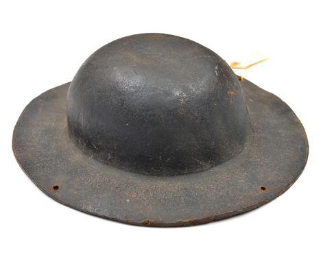 An interesting Cornish tin miner’s stout brown leather hat, in the style of an army tin helmet, formed from a single piece of