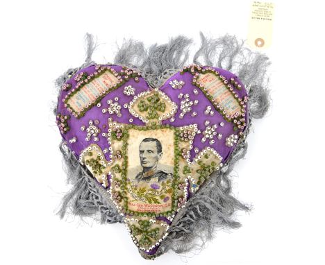 A heart shaped pin cushion with inset silk portrait of Maj Gen Wauchope, killed in action at Magersfontein 1899, crimson silk