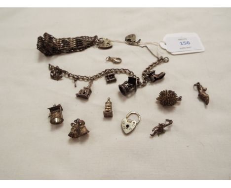 A selection of silver charms and a gate bracelet