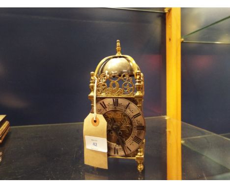 A 'Davall de Luxe' lantern clock with gilt case and silvered chapter ring with Roman numerals, surmounted with bell within a 