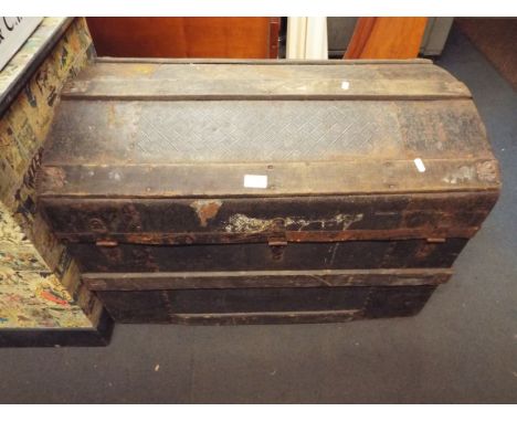A 19thC metal and wooden bound dome top shipping trunk with iron locks