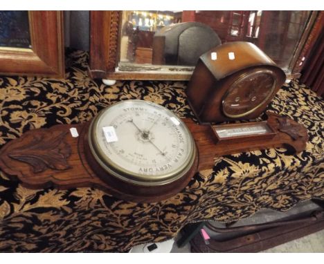 An oak cased aneroid barometer with thermometer above together with a Smiths walnut cased mantle clock