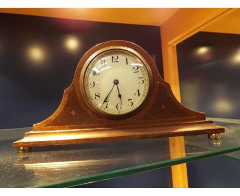An Edwardian Swiss made walnut dome top mantel clock, the enamel dial with Arabic numeral, the brass movement stamped 'Buren'