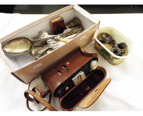 A box of assorted collectables to include camera in case, cutlery, coins, miniature chambersticks etc