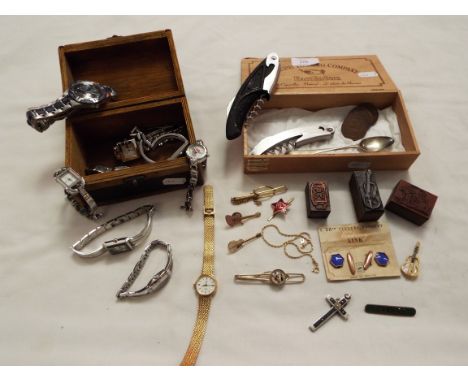 A trinket box containing watches and a vintage tobacco box with a selection of collectables including enamel pins, stamps, co