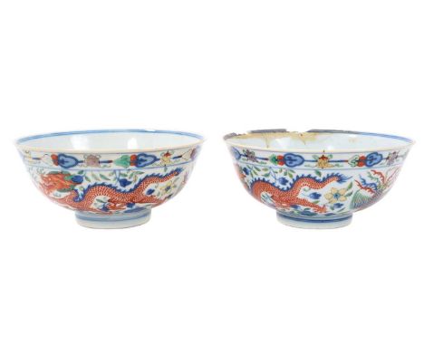 A pair of Chinese porcelain bowls, Daoguang mark and period, decorated with a dragon and phoenix pattern in the Wucai style, 