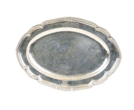 George III silver platter of oval form, with shaped gadrooned border, engraved with coat of arms and monogram, underside with
