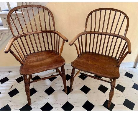 Near pair of 19th century elm stick back elbow chairs, with solid seats, on turned legs joined by castors