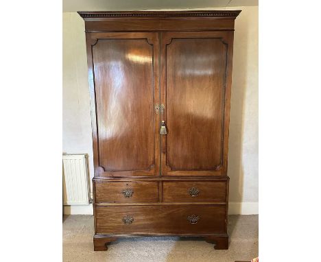 19th mahogany wardrobe with moulded dentil cornice, twin panelled doors enclosing hanging space, above two short and one long
