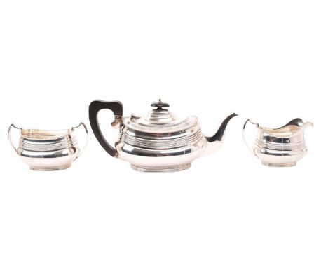1920s silver three piece tea set, comprising tea pot of ribbed form, with gadrooned border, hinged domed cover and ebony hand