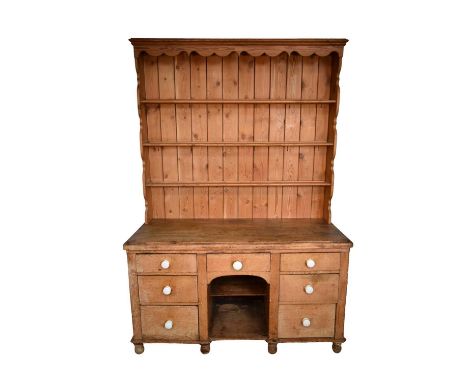 Victorian pine kitchen dresser base with later associated boarded rack, the base with six drawers about central dog kennel, 1