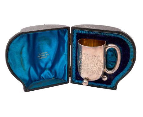 Victorian silver christening mug, with engraved fern leaf decoration, armorial crest and name and silver loop handle, on thre