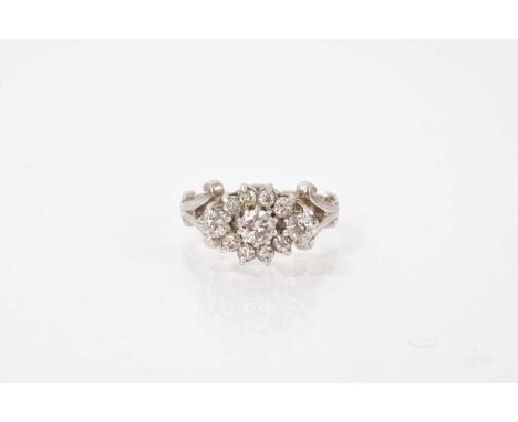 Diamond cluster ring with eleven brilliant cut diamonds in claw setting on platinum shank. Estimated total diamond weight app