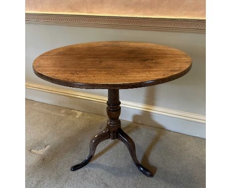George III mahogany tripod table, the circular tilt top supported on a turned column and three splayed legs, 74cm diameter