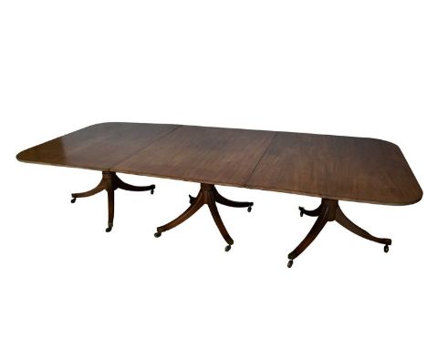 George III mahogany three pedestal dining table with two additional leaves, the well figured rounded rectangular top raised o