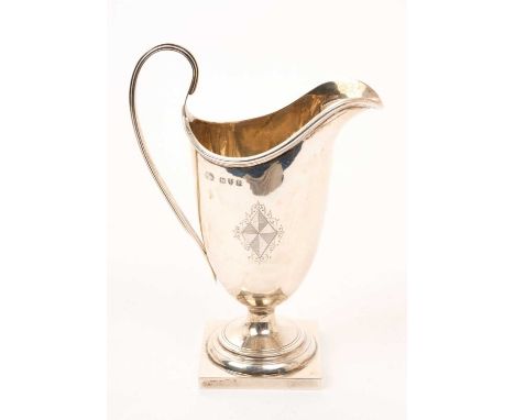 Late Victorian silver cream jug of helmet form, with engraved shield and initials and reeded handle, on a square pedestal bas