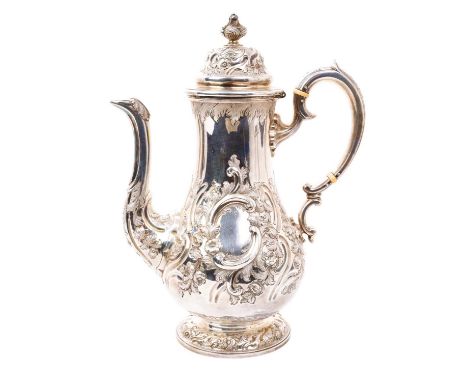 Victorian Scottish silver coffee pot of baluster form, with embossed scroll and foliate decoration and engraved presentation 