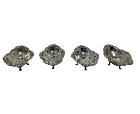 Set of four American sterling silver bon bon dishes of shaped form, with scroll borders, on paw feet. Undersides stamped BIRK