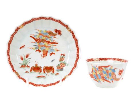 A very rare Worcester tea bowl and saucer, circa 1755-60, of fluted form, polychrome painted in the Japanese style with the '