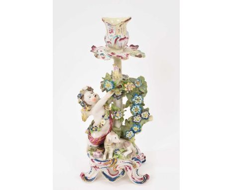A Bow candlestick, circa 1765, in the form of a putto bird's nesting, with a dog by his side, polychrome painted, the base wi
