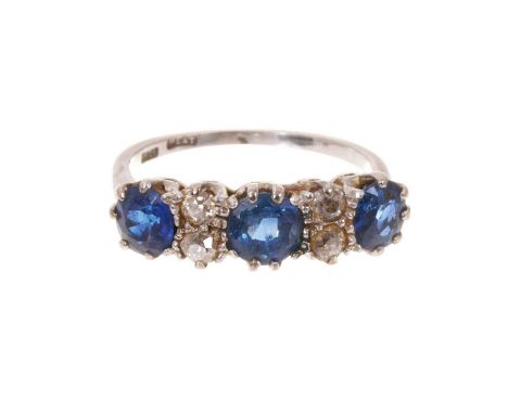 Antique sapphire and diamond ring with three mixed cut blue sapphires and four old cut diamonds in platinum claw setting on 1