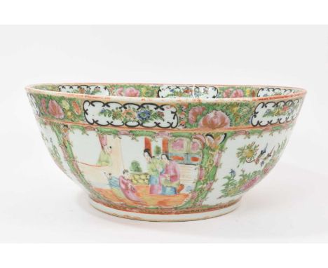 A large Chinese Canton famille rose porcelain round bowl, circa 1880-1900, painted with panels containing figural scenes, flo