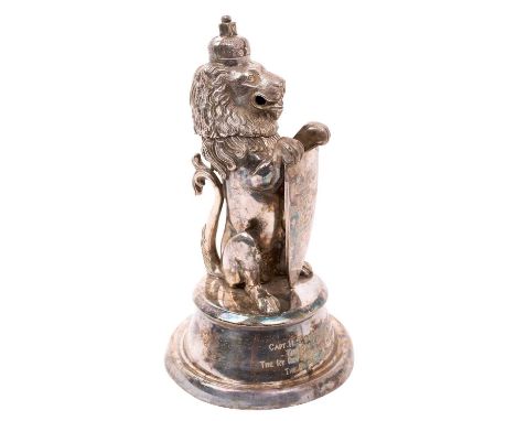 A Victorian silver plated desk inkwell in the form of a heraldic lion, with hinged head, holding a shield engraved "The Illus