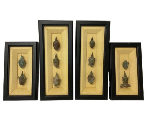 Collection of ten ancient Thai fragmentary bronze heads, the largest approximately 6cm high, presented in four frames  Specim
