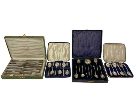 Cased set of six apostle teaspoons, pair tongs and a sugar sifter spoon, two cased sets of six silver golfing teaspoons (vari