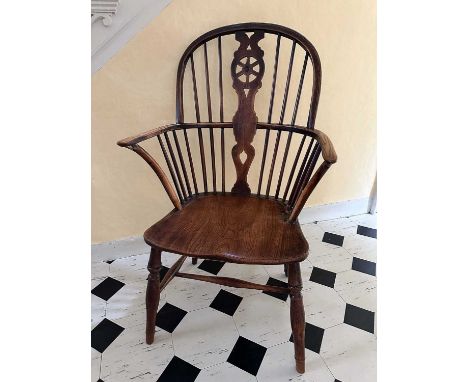 19th century ash, elm and fruitwood stick back Windsor chair, with shaped wheelback splat, solid seat and turned legs joined 